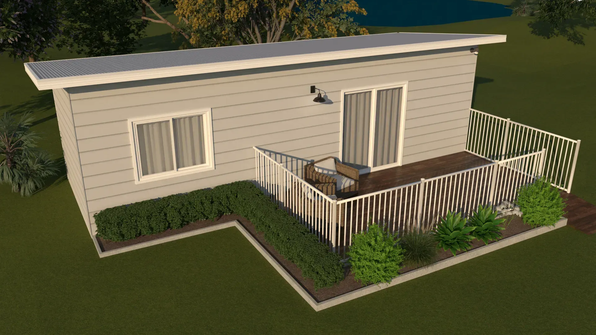 A light-colored building with a deck, surrounded by landscaping, viewed from above.