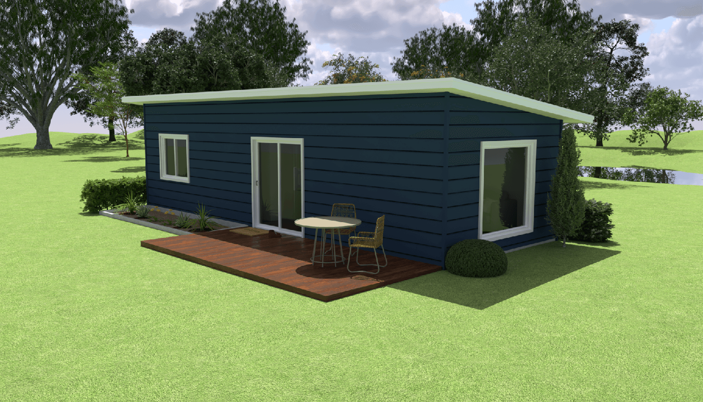 Blue modern house with a deck, table and chair on a grassy lawn with trees and a pond in the background.