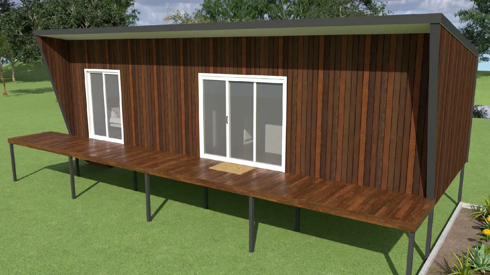 Modern, brown cabin with a deck, sliding doors, and a sloping roof on green grass.