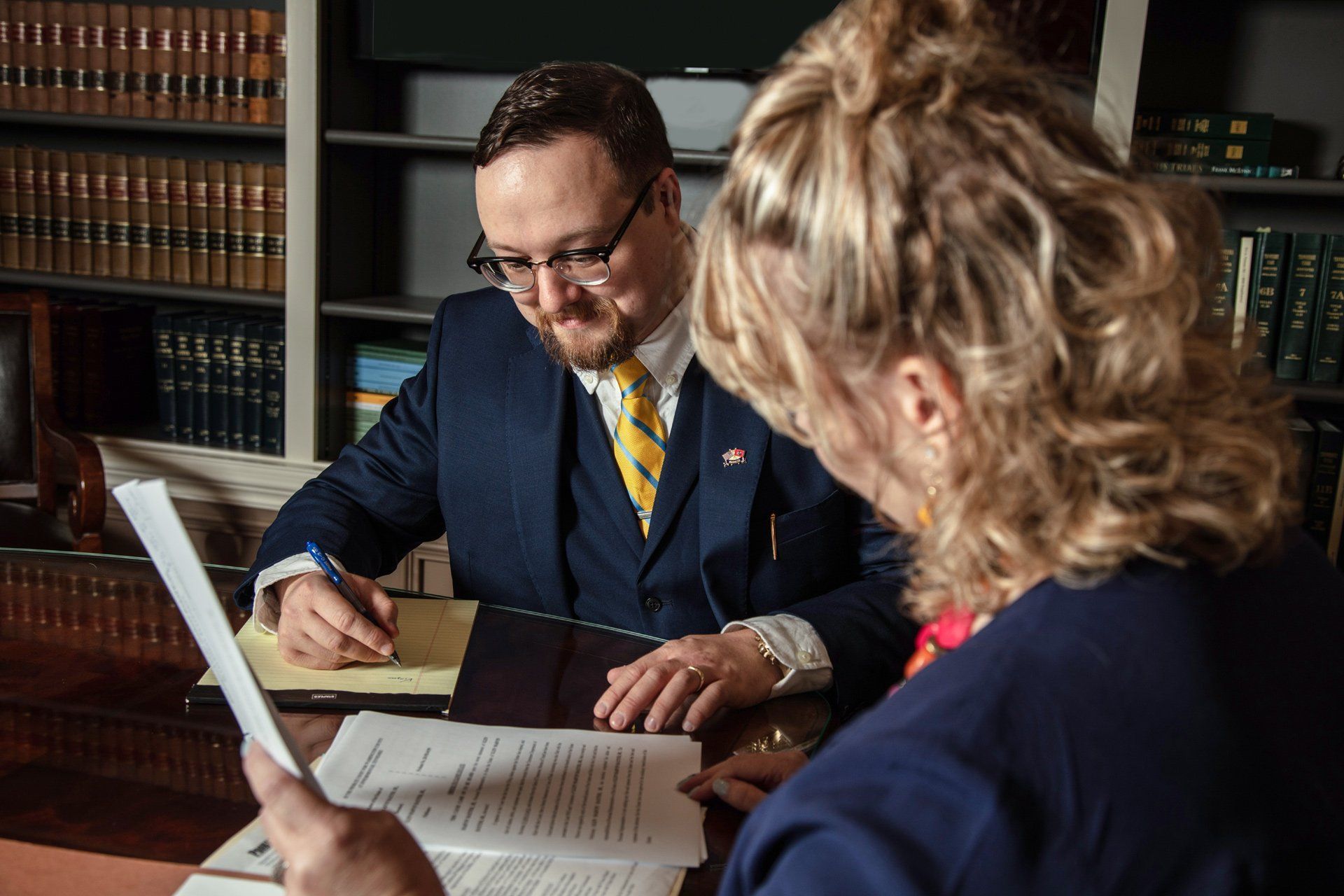 Attorney Musgrove and a woman are sitting at a table looking at papers – Jonesborough, TN - Law Offices of James R Wheeler