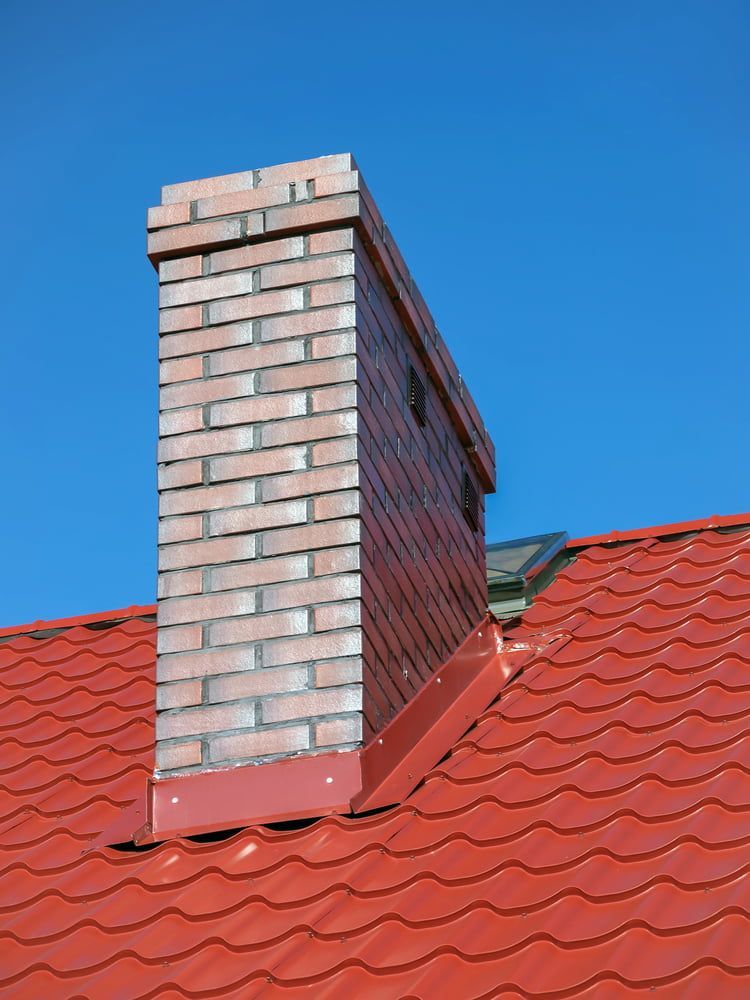 A Brick Chimney On Top Of A Red Tiled Roof — Central West Budget Tree Services in Dubbo, NSW