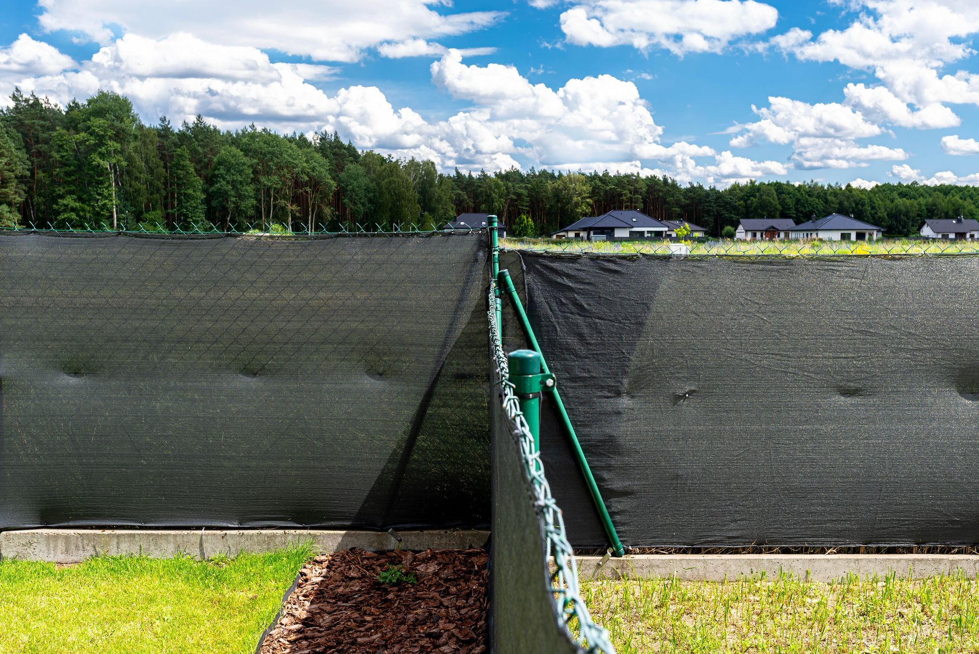 Commercial chain link fence installation with wind screens in Tampa, FL
