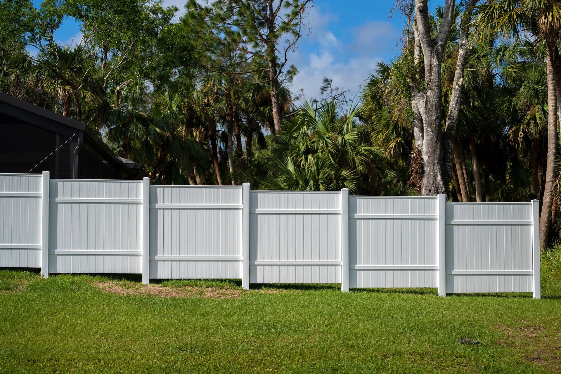 White commercial vinyl privacy fence installation by McConnie Fence