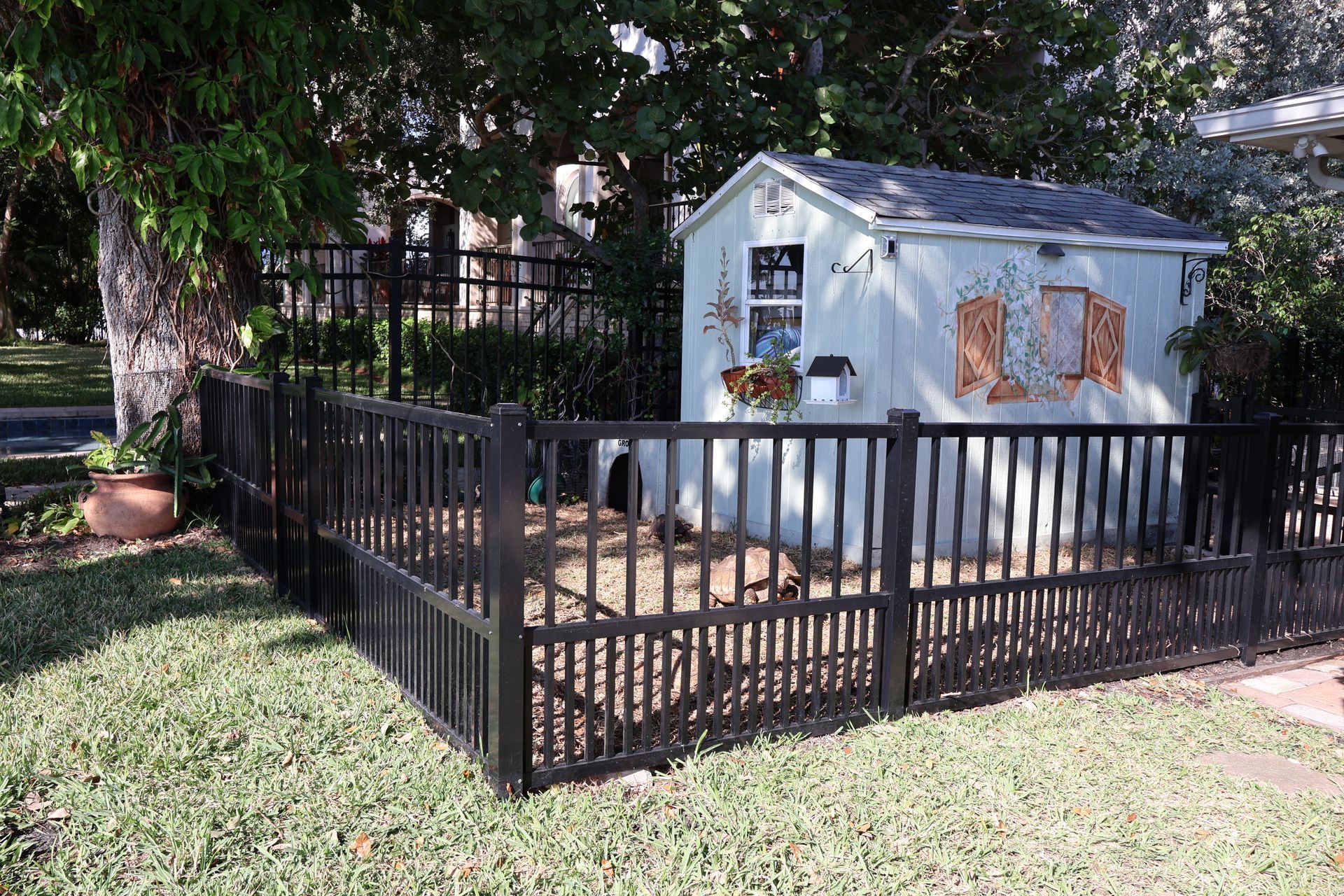 Residential aluminum fence installation around a shed in Tampa, FL