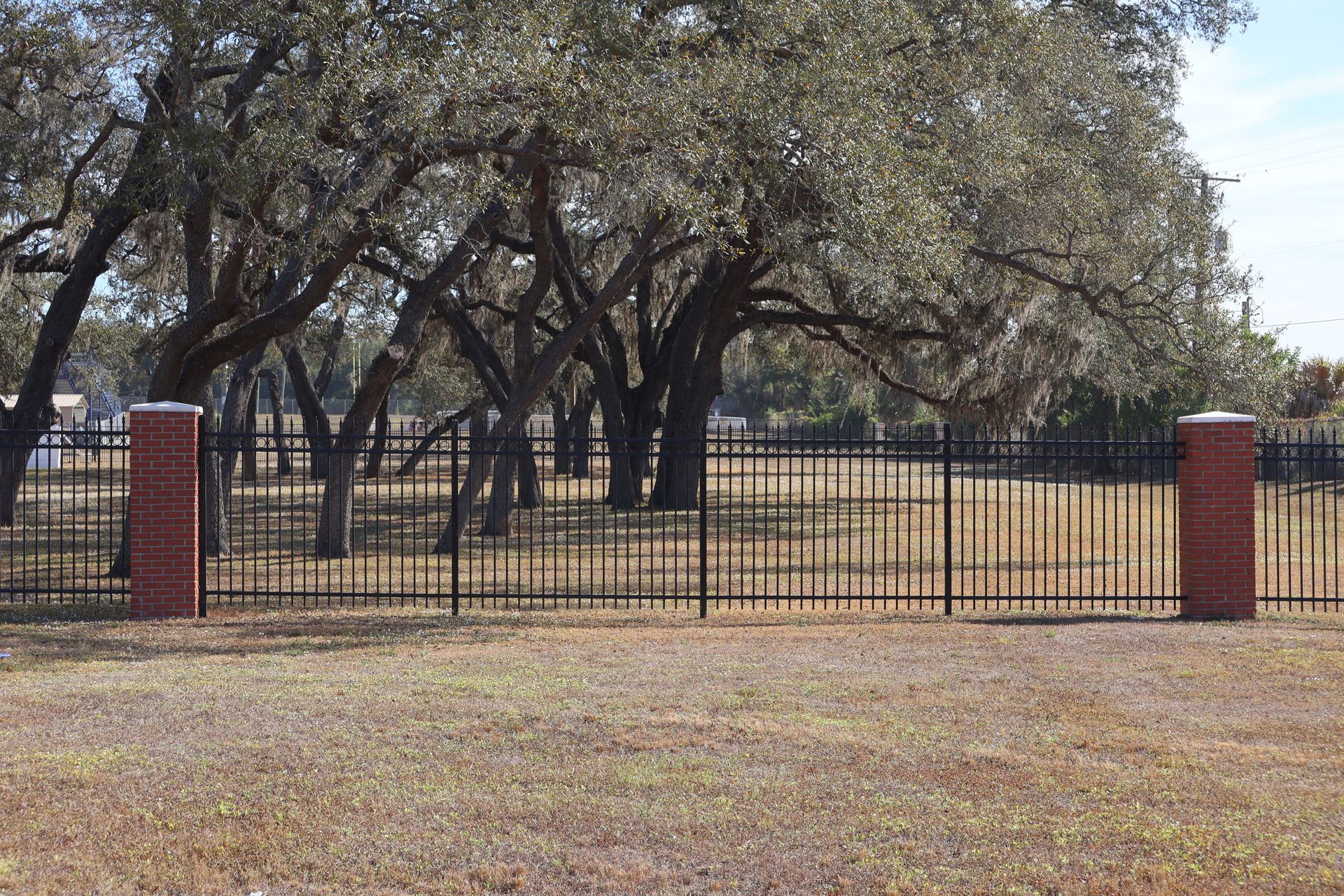 Commercial aluminum fence installation with brick posts in Tampa, FL