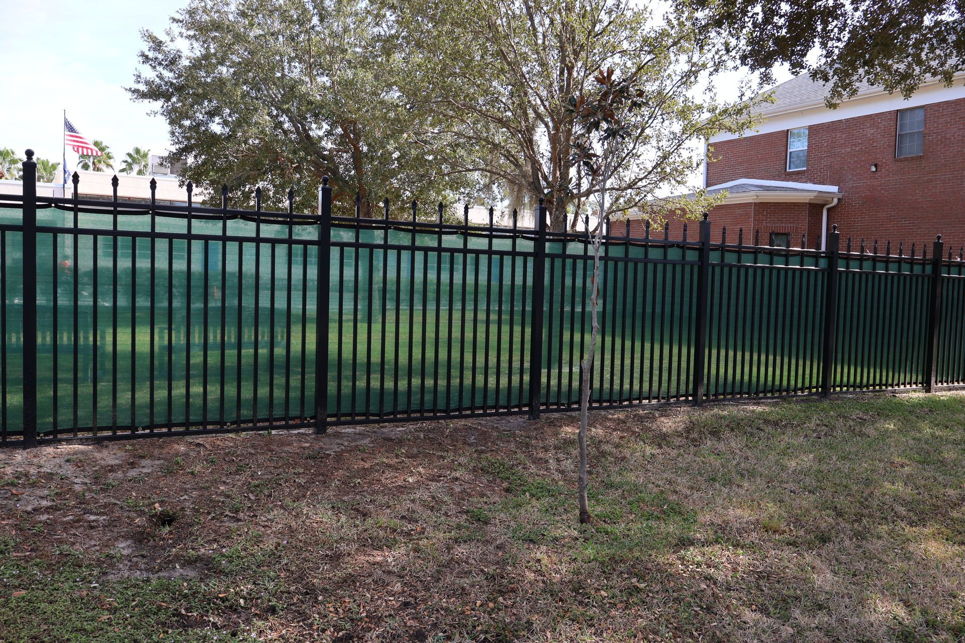 Commercial decorative aluminum picket fence installation with a privacy screen in Tampa, FL