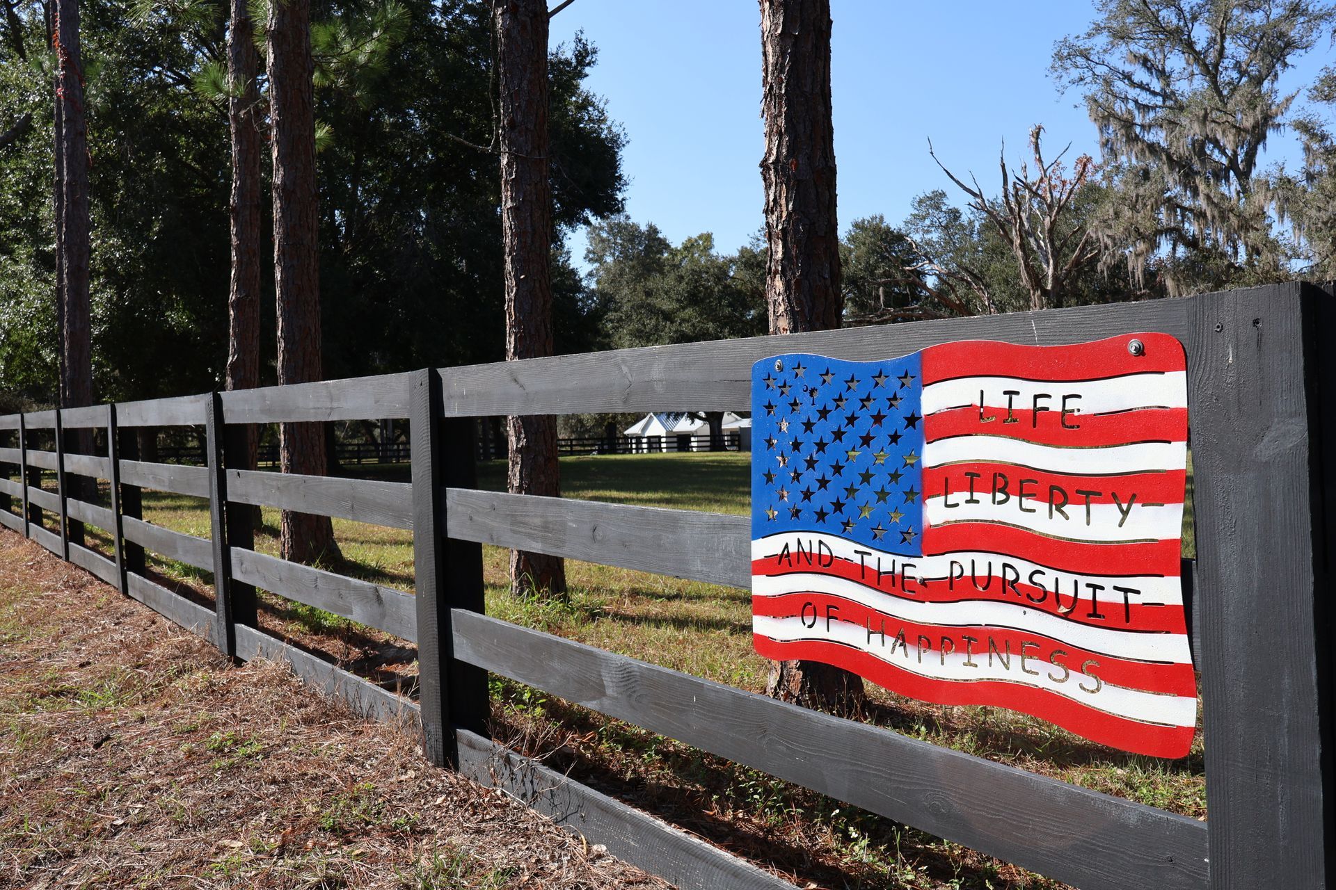 Residential split rail black wood fence installation in Tampa, FL