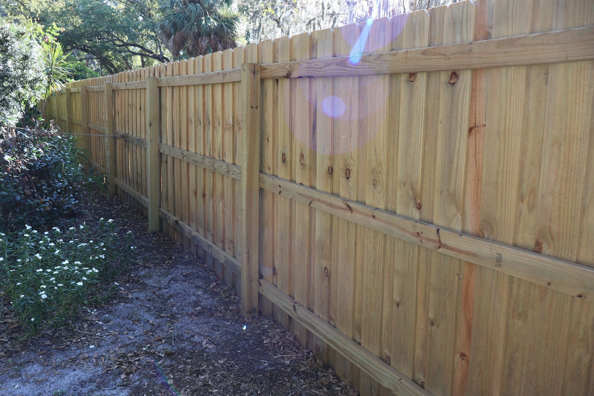 Residential wood privacy fence installation in a backyard in Tampa, FL