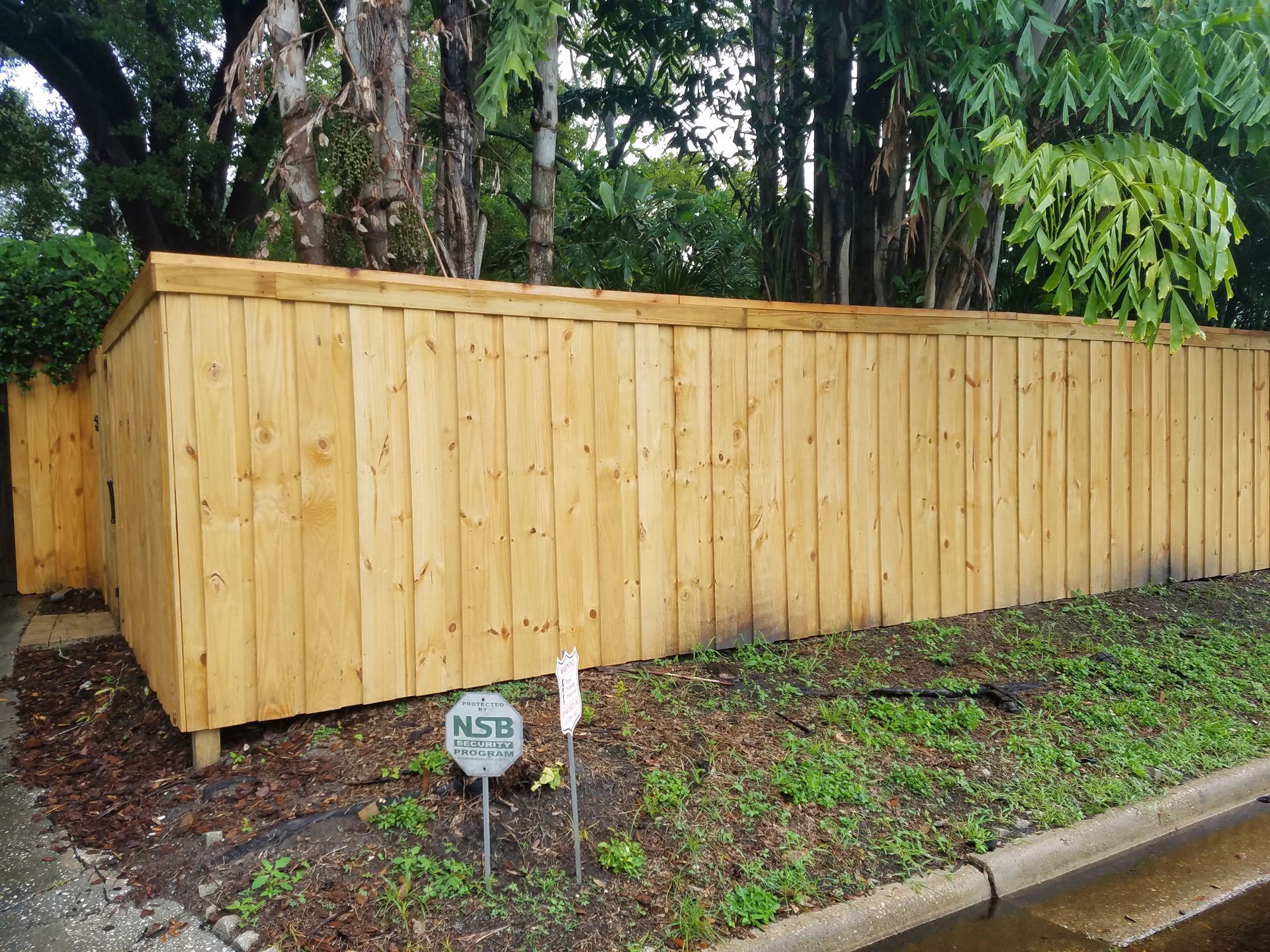 Residential wood privacy fence installation in a backyard in Tampa, FL