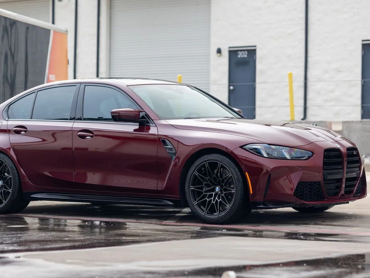 Red BMW M3 parked outside Humble Crew Auto Spa.