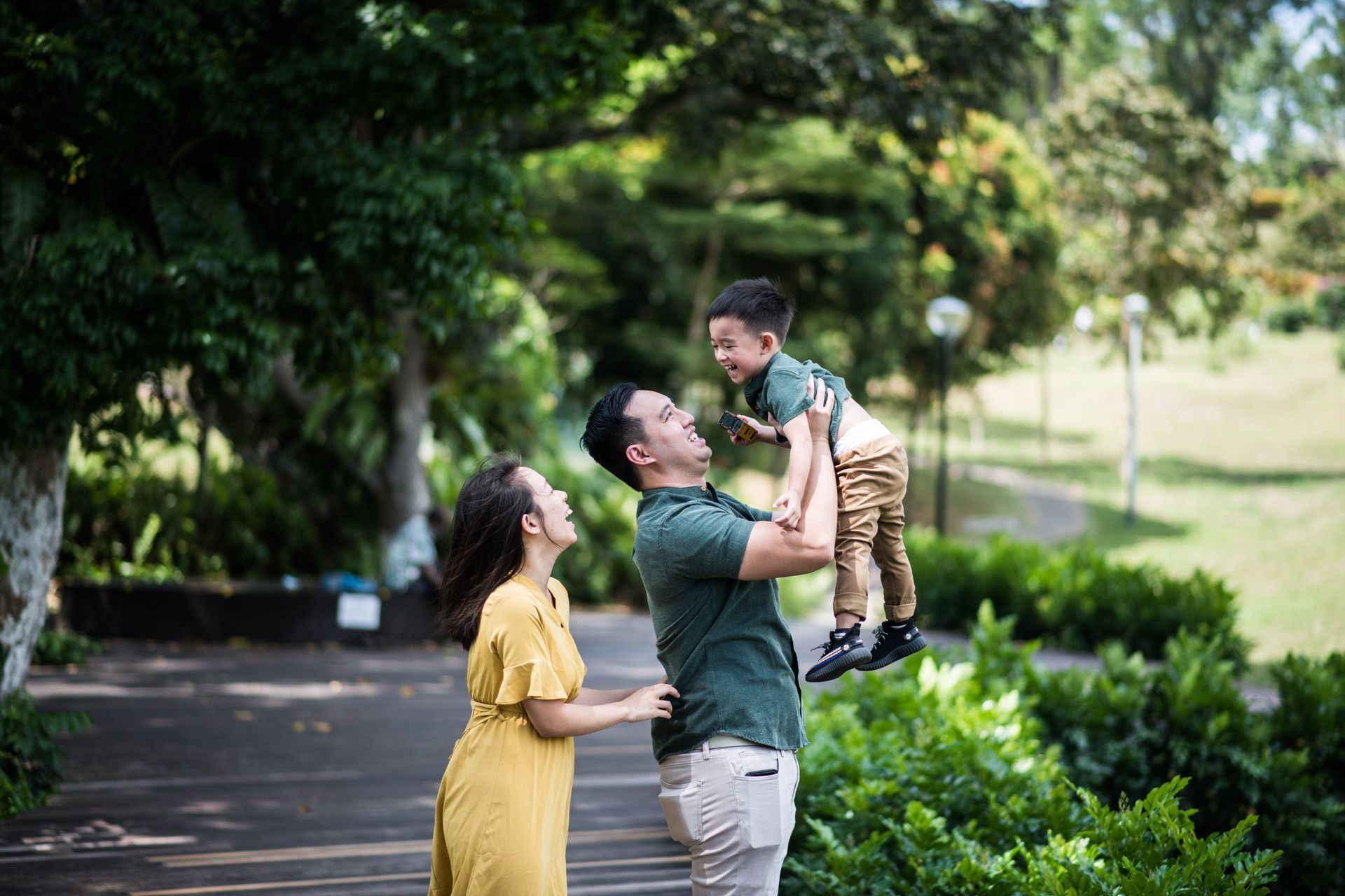 Smiling family taking a selfie in front of a traditional temple building