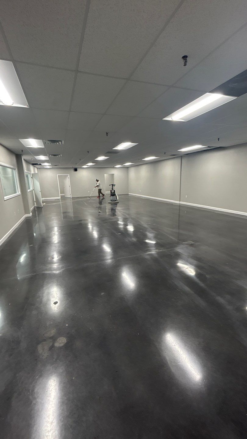 Empty polished hallway with glossy black floor, white walls, and ceiling lights
