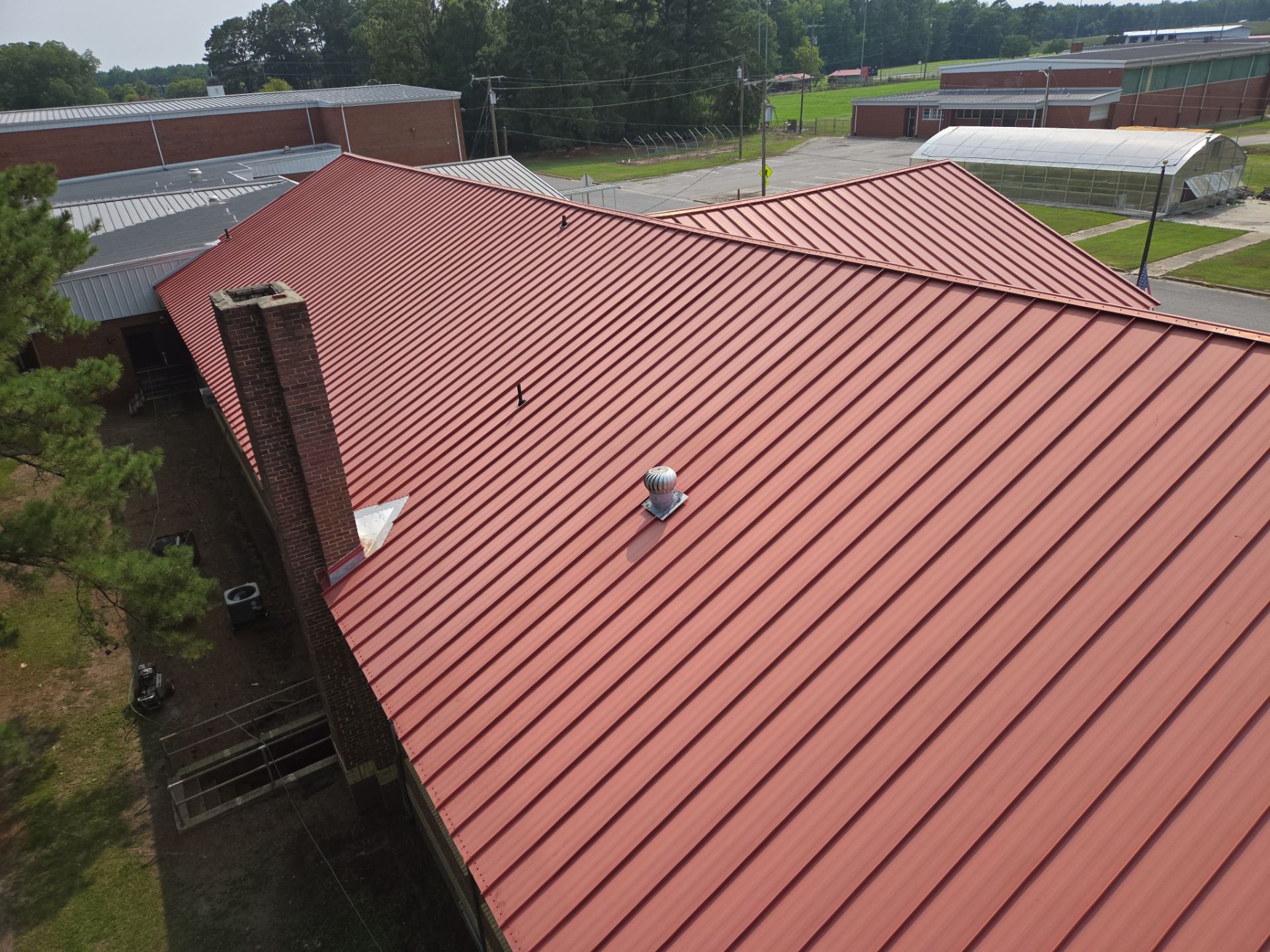 White building exterior with ramps and railings under a cloudy sky.