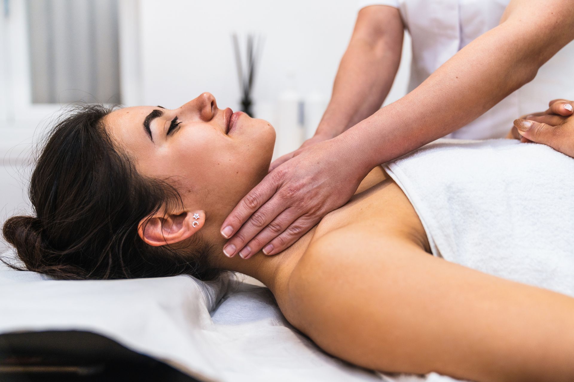 A pregnant woman is getting a massage from a man.