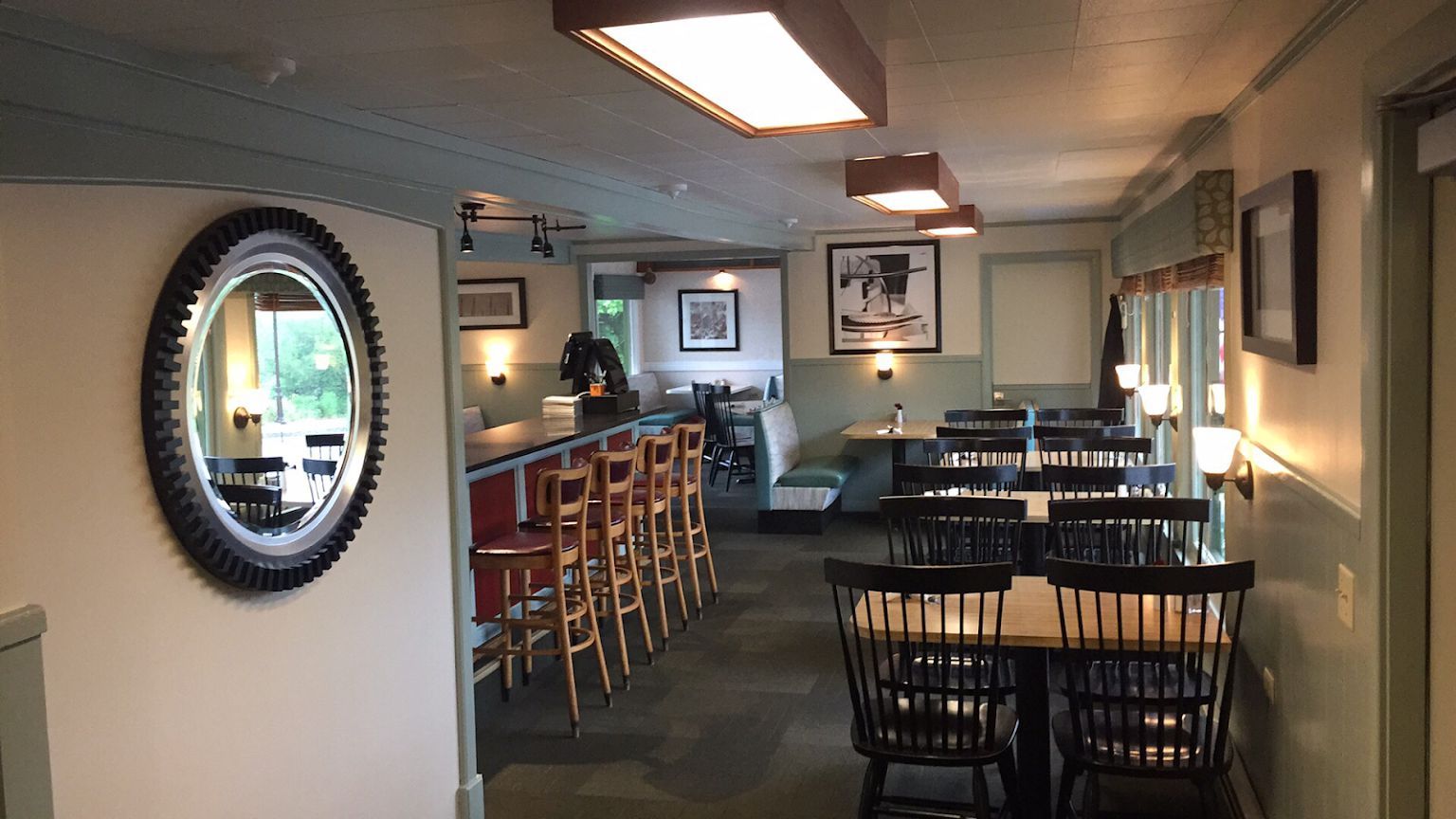 Chases restaurant with tables and chairs and a mirror on the wall located in Winter Harbor, the quiet side of Acadia.