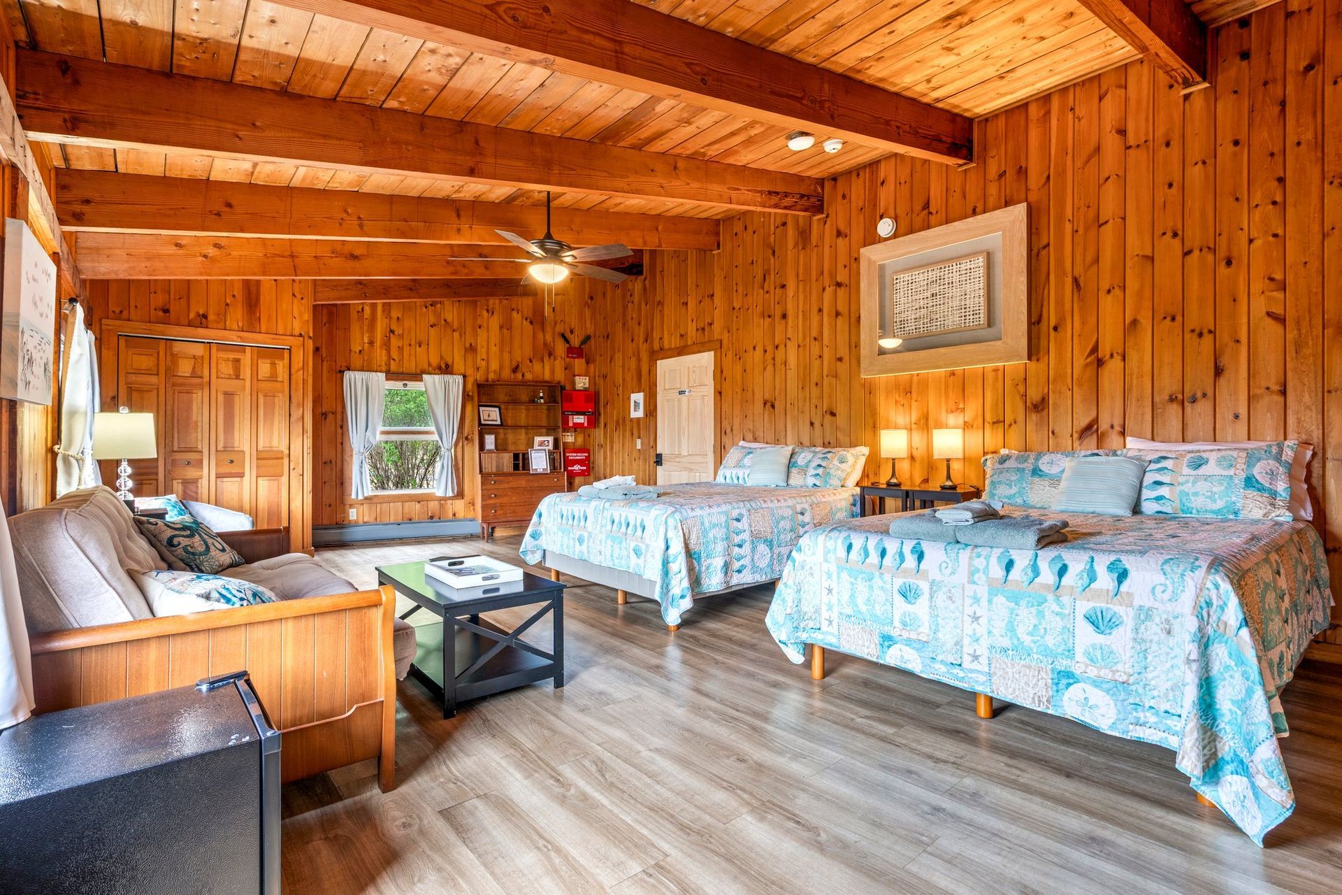 Stay in this first floor cozy bedroom with two queen beds and a sofa.  This room is located at the Bluff House Inn.