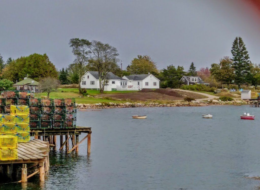 Harbor with lobster traps on a dock, red buoys in the calm bay located near the Bluff House Inn