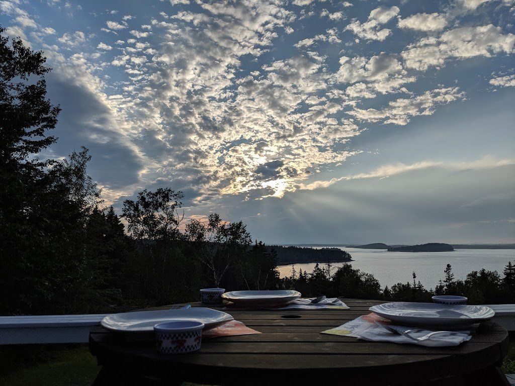 The sun is shining through the clouds overlooking Frenchman Bay