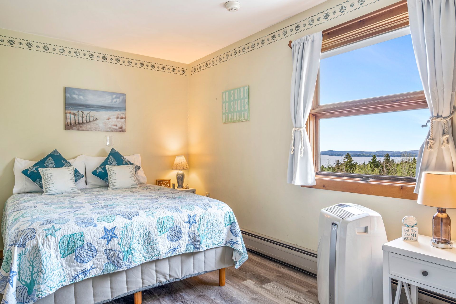 Stay in this cozy bedroom and enjoy summer sunsets, ocean views, and the serenity of the quiet side of Acadia.