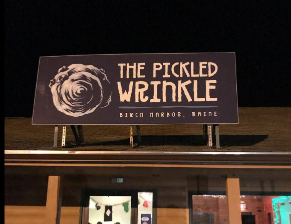 Sign for “The Pickled Wrinkle” restaurant at night, located in Winter Harbor near the Bluff House Inn.