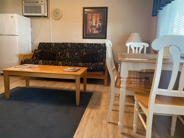 A living room with a couch a table and chairs
