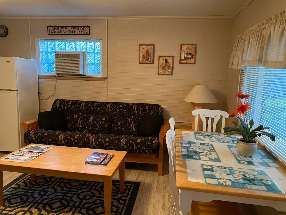 A living room with a couch , table and chairs