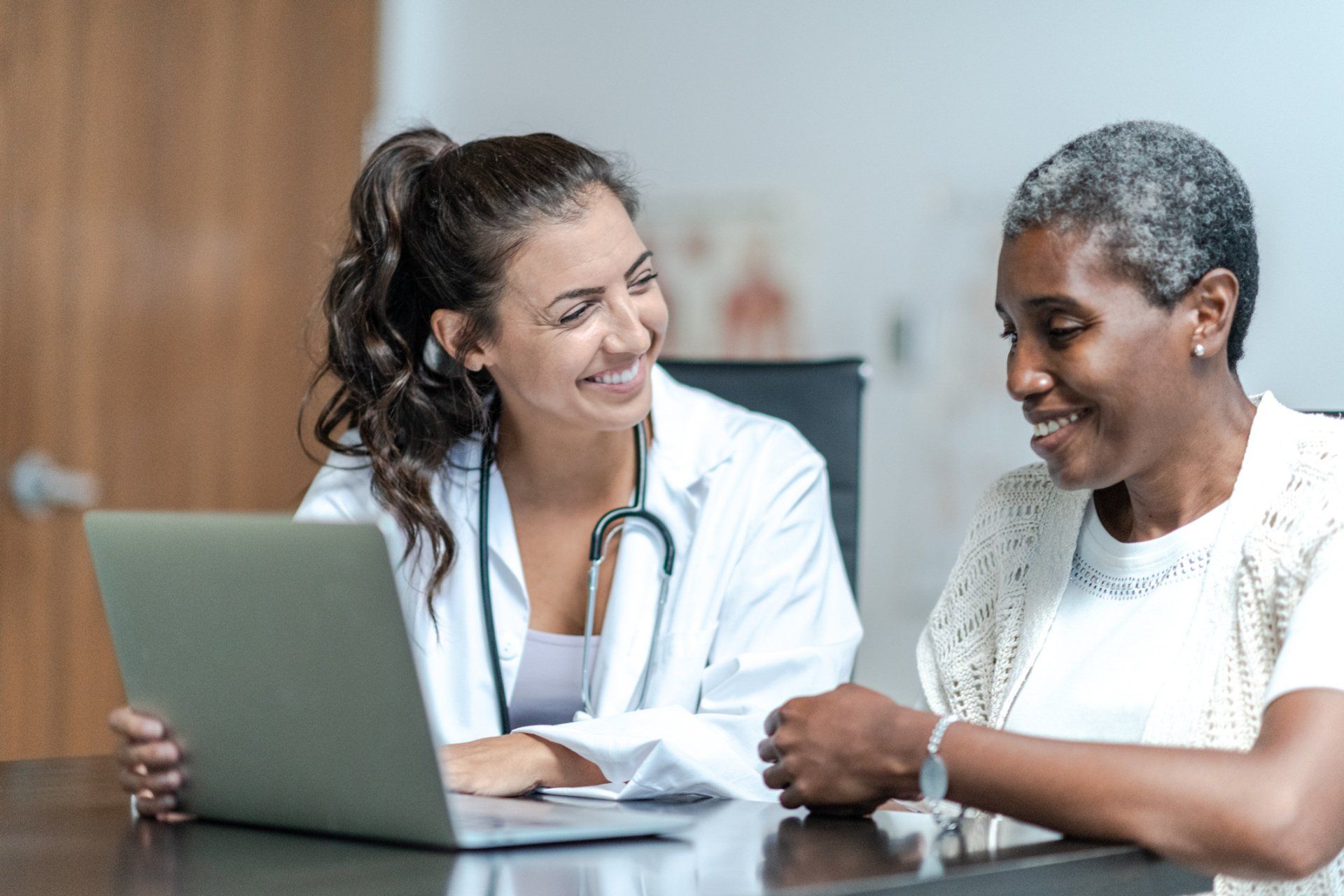 Young female doctor with elderly patient — New Hartford, NY — Oxford Medical Imaging