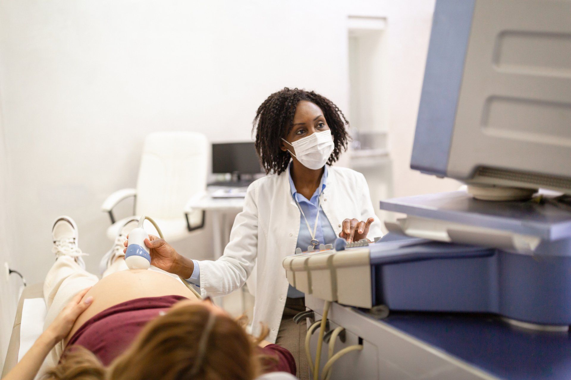African-american female doctor doing ultrasound check — New Hartford, NY — Oxford Medical Imaging