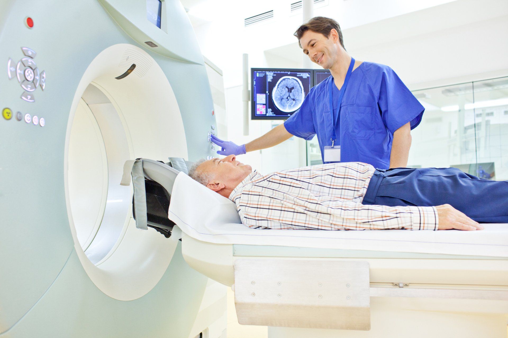 Patient and medical technician at the computer tomography getting a scan — New Hartford, NY — Oxford Medical Imaging Patient and medical technician at the computer tomography getting a scan — New Hartford, NY — Oxford Medical Imaging