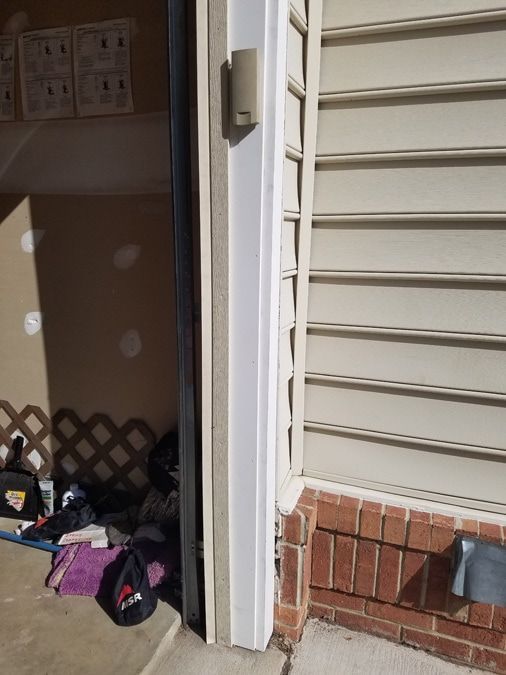A door that is open to a room with a brick wall