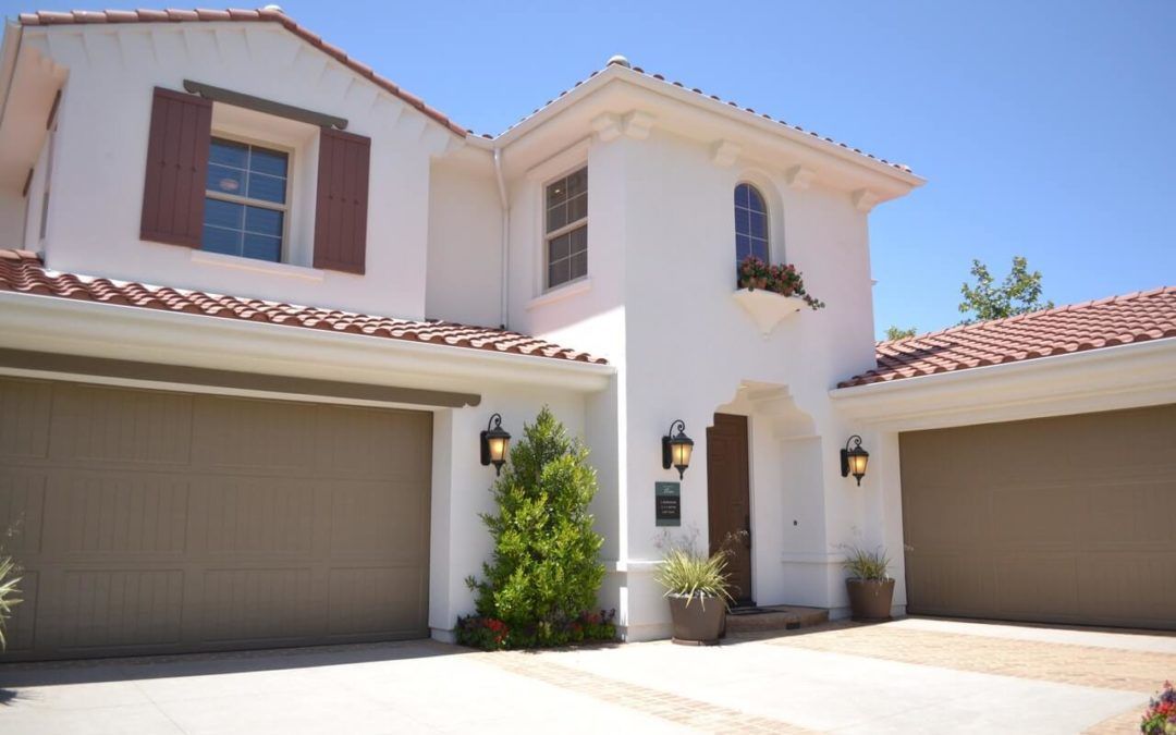 A large white house with three garage doors