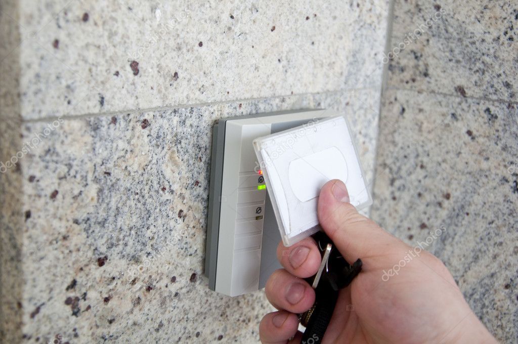 a person is using a key card to open a door .