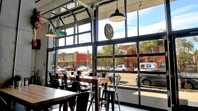 a restaurant with tables and chairs and a large window .
