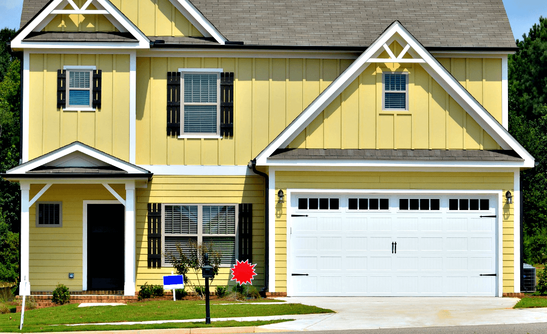 A yellow house with a white garage door and black shutters