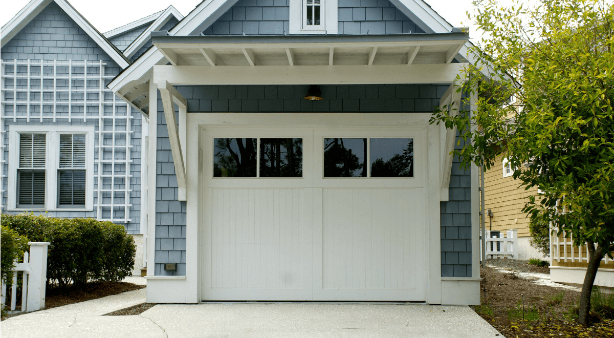 A blue and white house with a white garage door.
