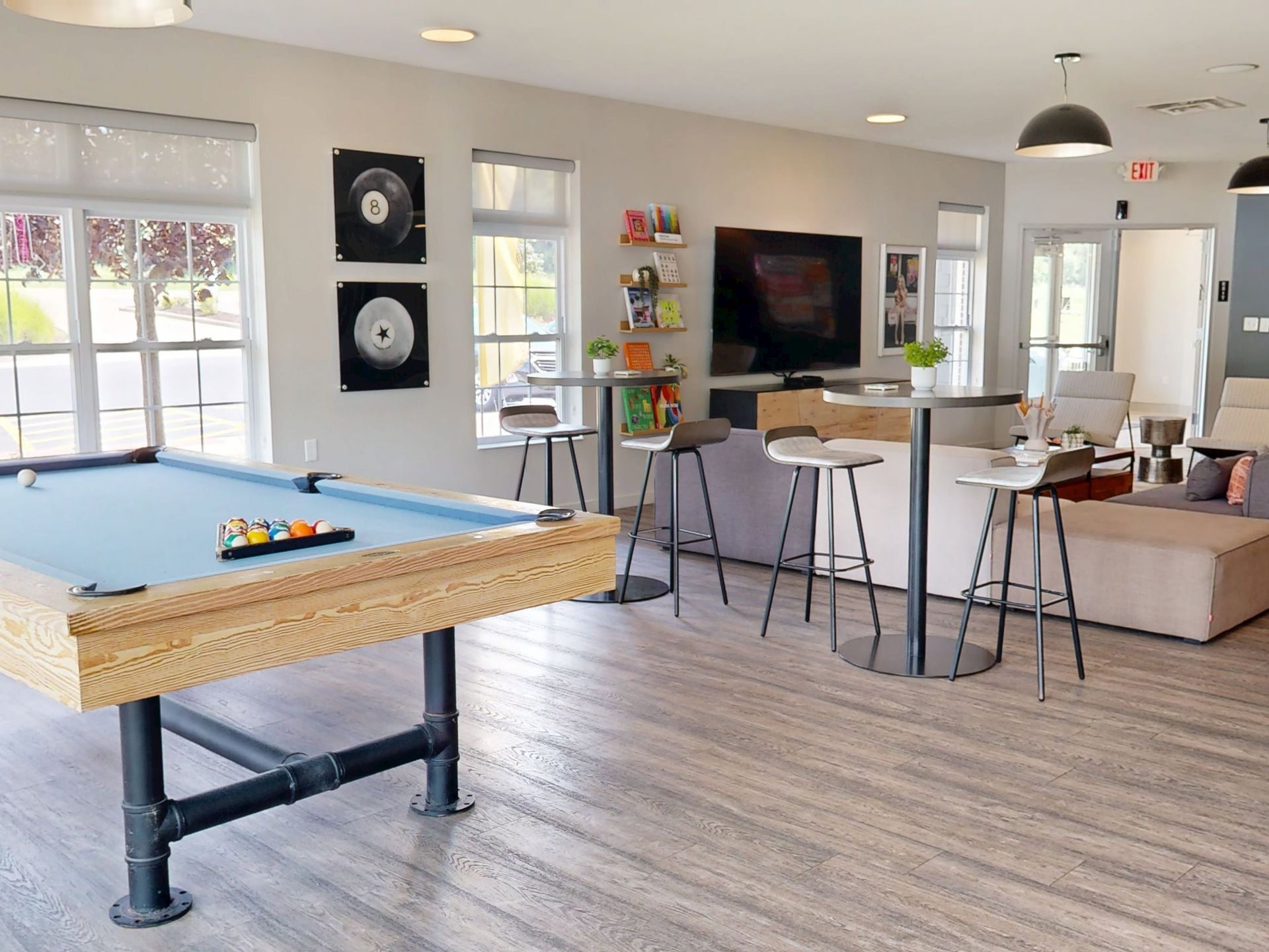 Spacious lounge area with modular sofas, a bar, and decorative lighting.