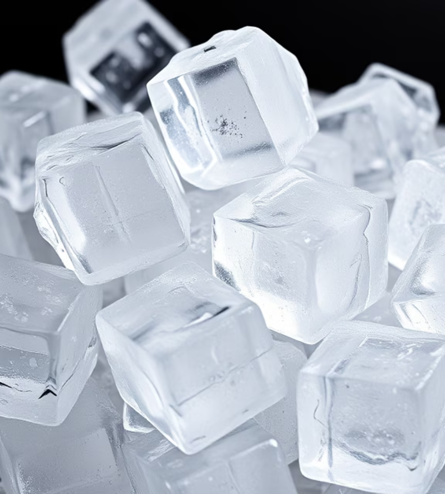 A collection of translucent, clear ice cubes piled together against a dark background.