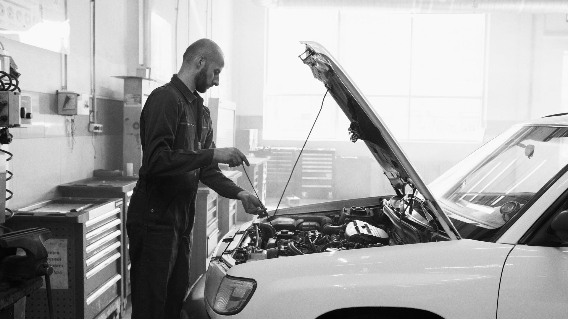 Technician inspecting a vehicle engine during an Alberta Out of Province Inspection in Calgary