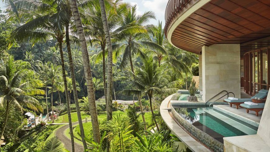 Balcony with infinity pool overlooking lush tropical landscape. Four Seasons Resort Bali at Sayan