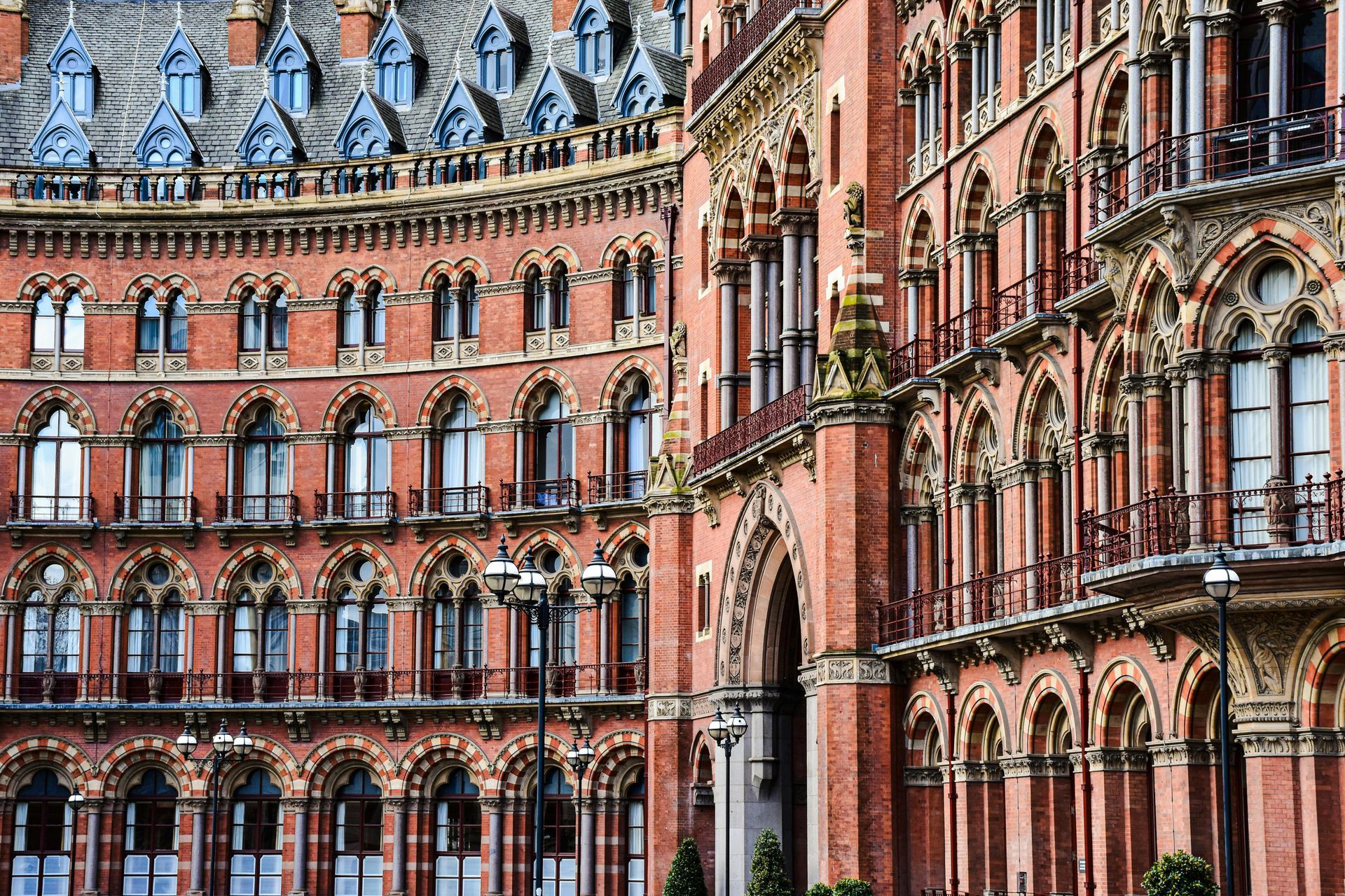Ornate red brick facade of St. Pancras Renaissance Hotel, London, with arched windows and intricate detailing.