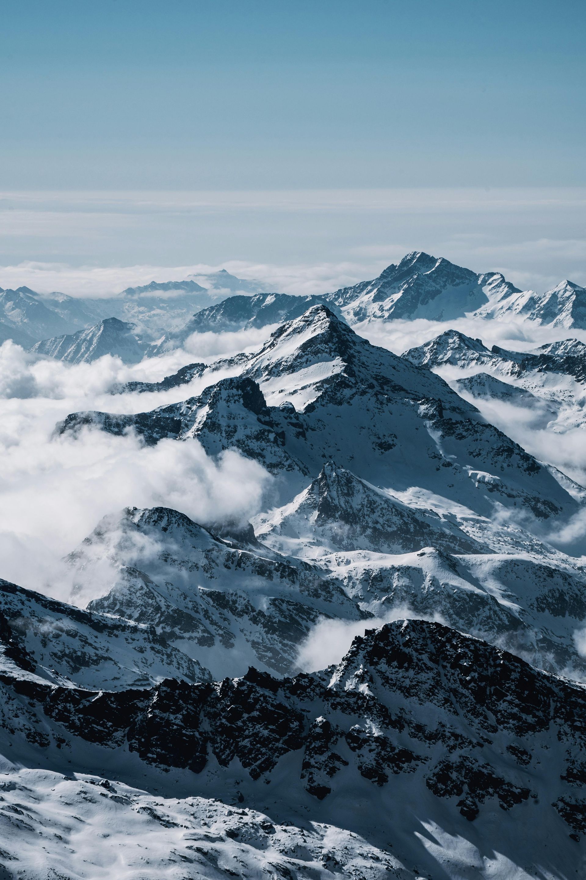 The Matterhorn mountain with snow-capped peak against a clear blue sky, seen from a forested hillside. View from The Omnia Hotel