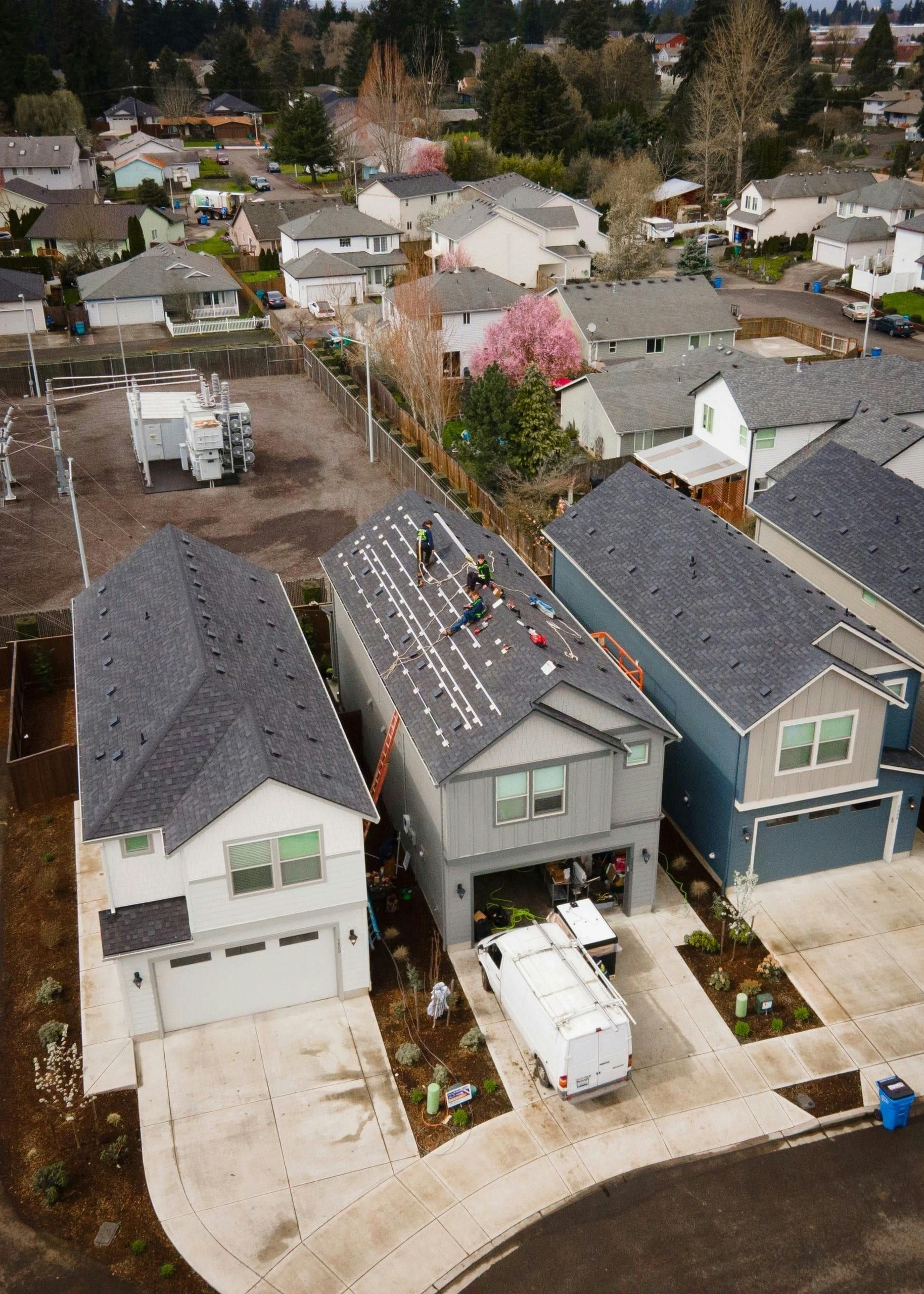 Emergency roofing repair vs full roof replacement comparison featuring a modern home roof with solar