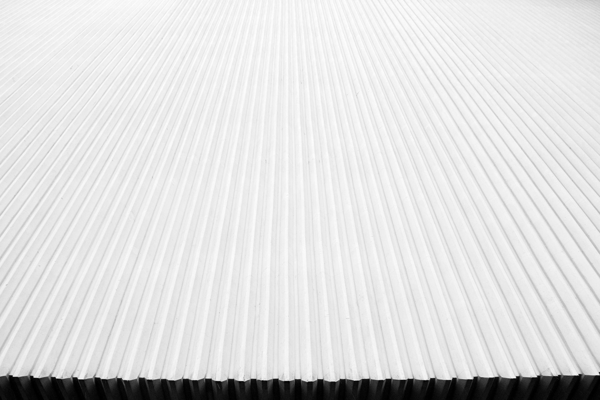 A close up of a white corrugated metal sheet.