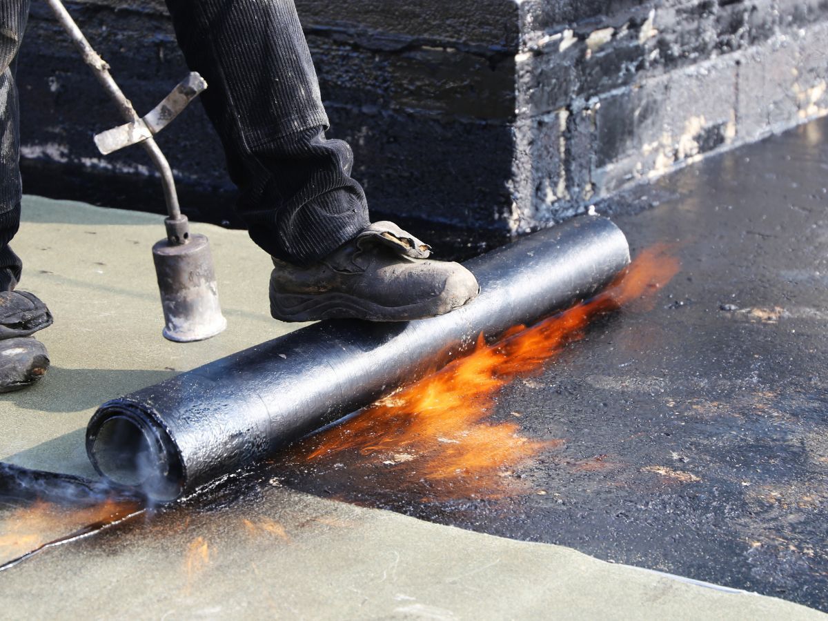 Pros & cons of modified bitumen roofing shown on a flat roof installation with layered membrane 