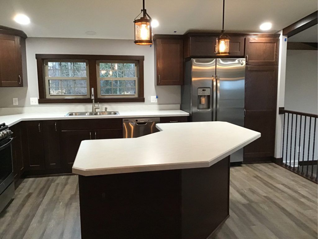 A kitchen with a large island and stainless steel appliances.