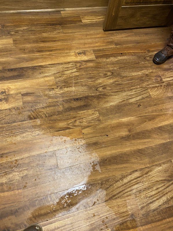 A wooden floor which has been damaged by sewer backup. 