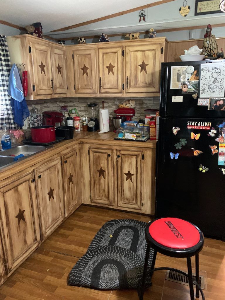 The kitchen before the restoration - water damage was underneath the cabinets.