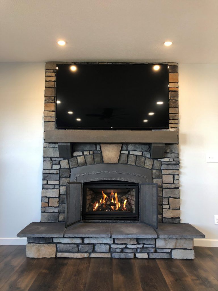A fireplace with a flat screen tv above it.