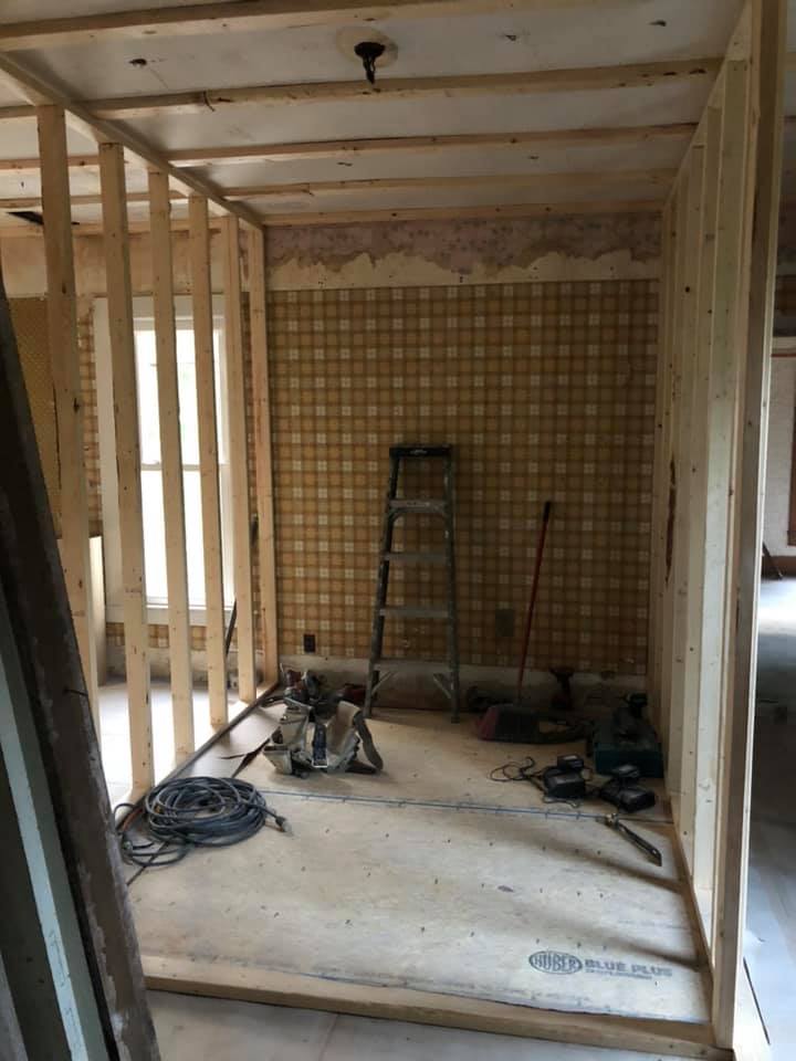A room under construction with a ladder on the floor.