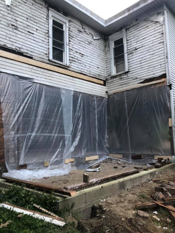 First floor of the farmhouse closed off by wrapping for ventilation purposes.